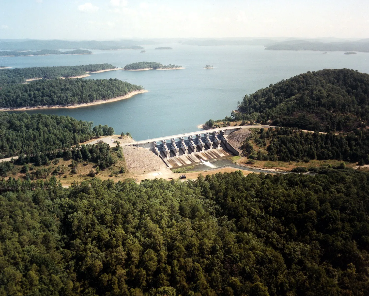 Aerial view of Broken Bow Lake, the spillway, and the surrounding forest