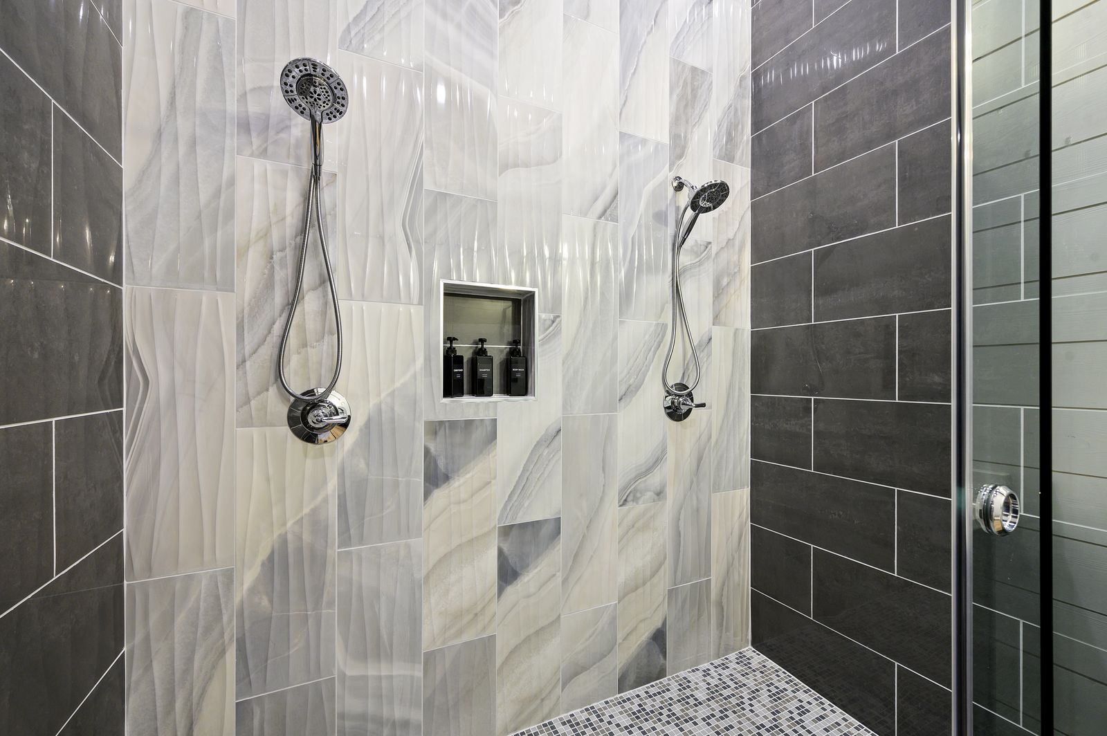 Double vanity bathroom at The Arcadia with dark espresso cabinets, dual mirrors, and white countertops