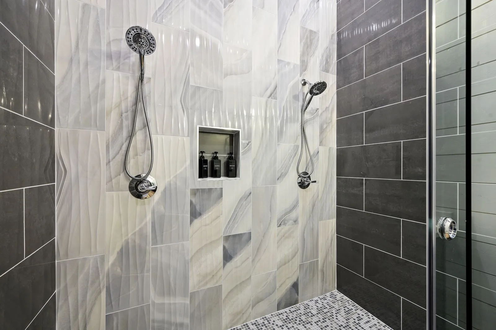 Double vanity bathroom at The Arcadia with dark espresso cabinets, dual mirrors, and white countertops