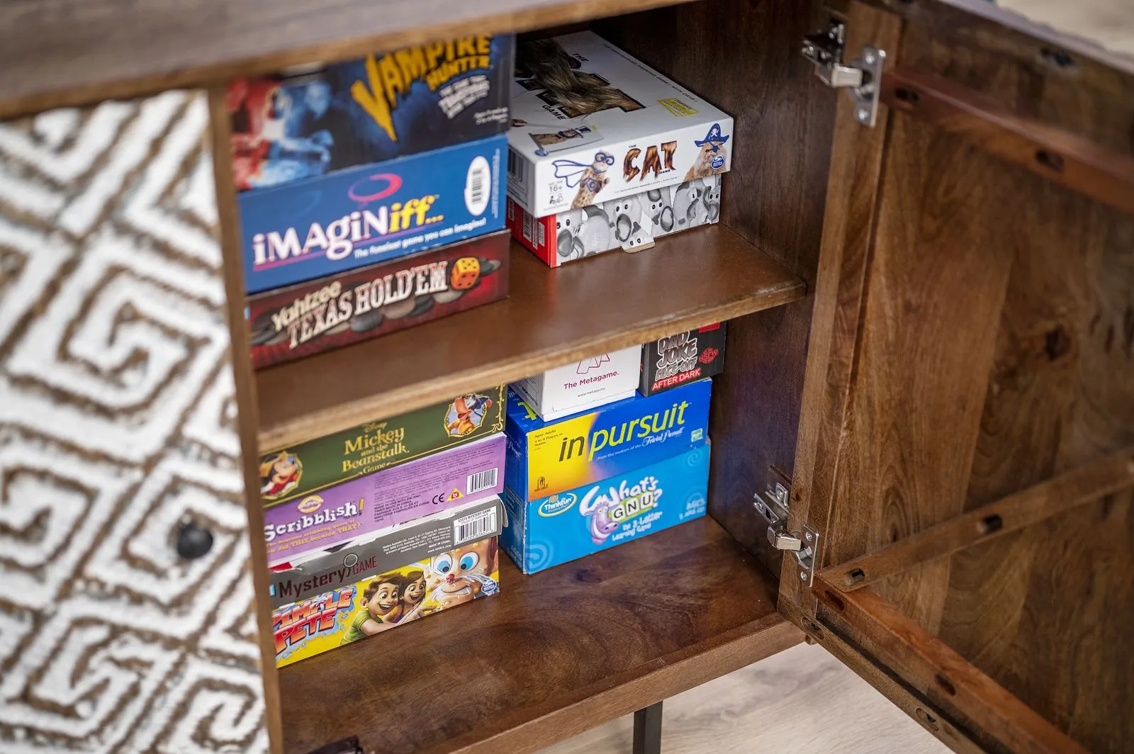 Retro arcade cabinet in the lower level game room at The Arcadia with wood paneling and LED strip lights