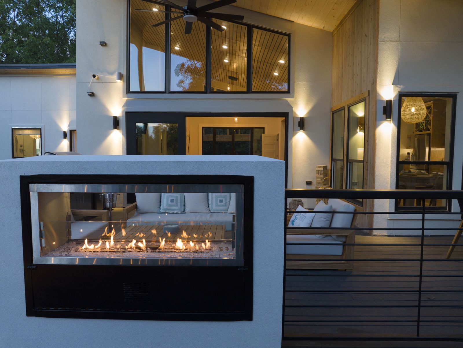 Front exterior at twilight with dual-sided fireplace at The Aroha