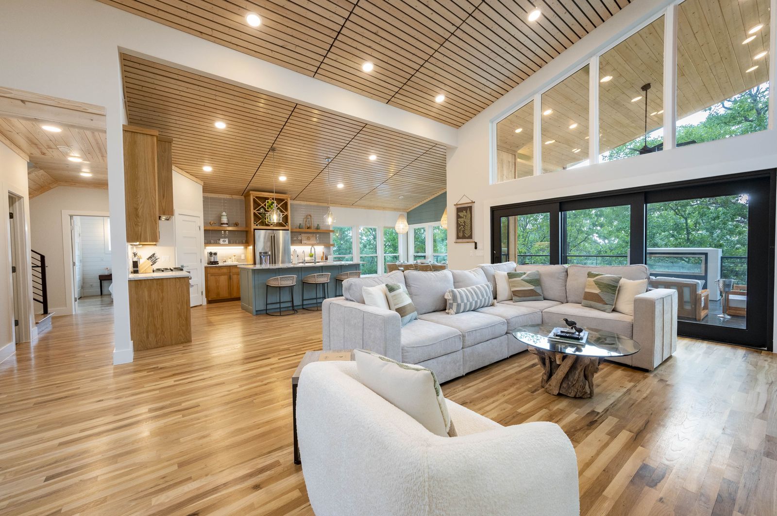 Open-concept great room with slatted wood ceiling at The Aroha