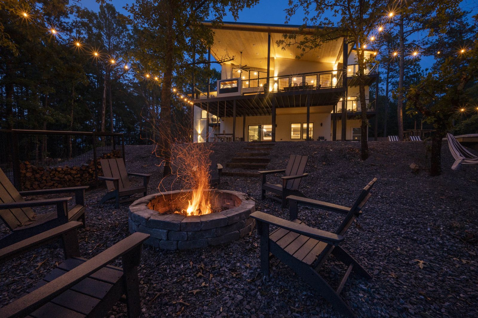 Multi-level exterior at dusk with warm interior glow at The Aroha