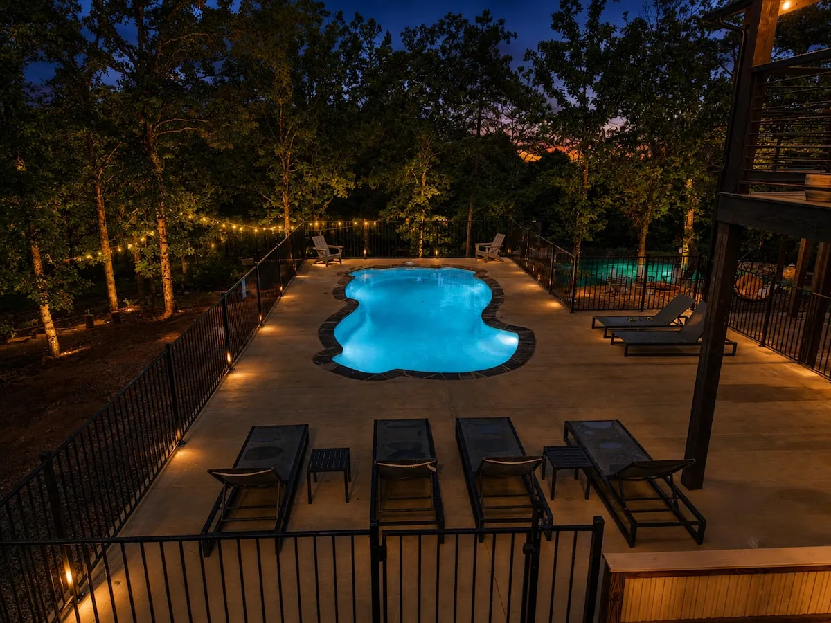 The Aroha luxury cabin in Broken Bow with heated pool at twilight
