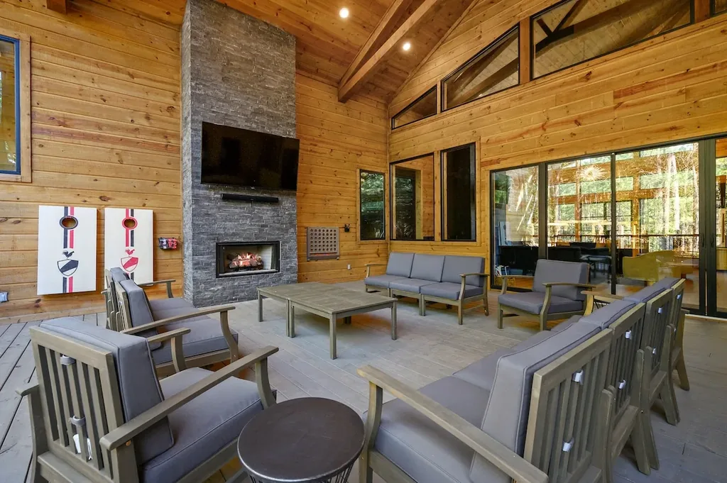 Covered outdoor seating arranged around the stone fireplace