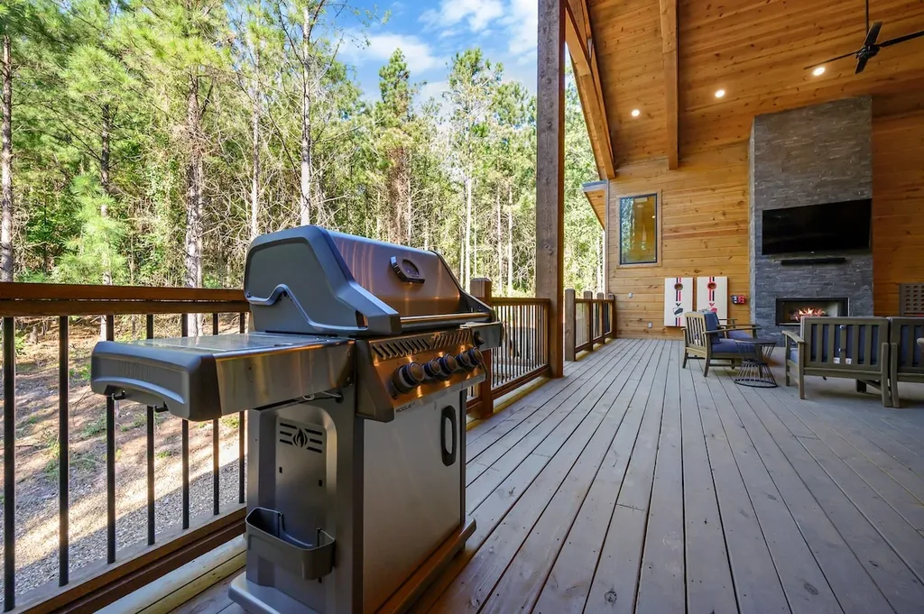 Stainless gas grill on the forest-facing deck