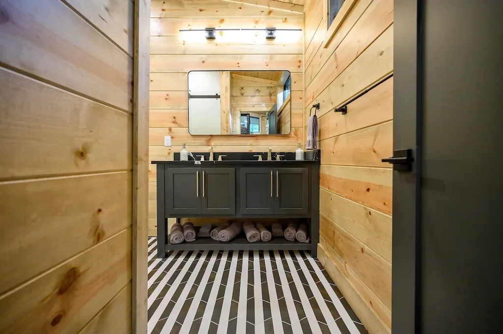 Full Bathroom 5 double vanity at the end of a wood-paneled hall