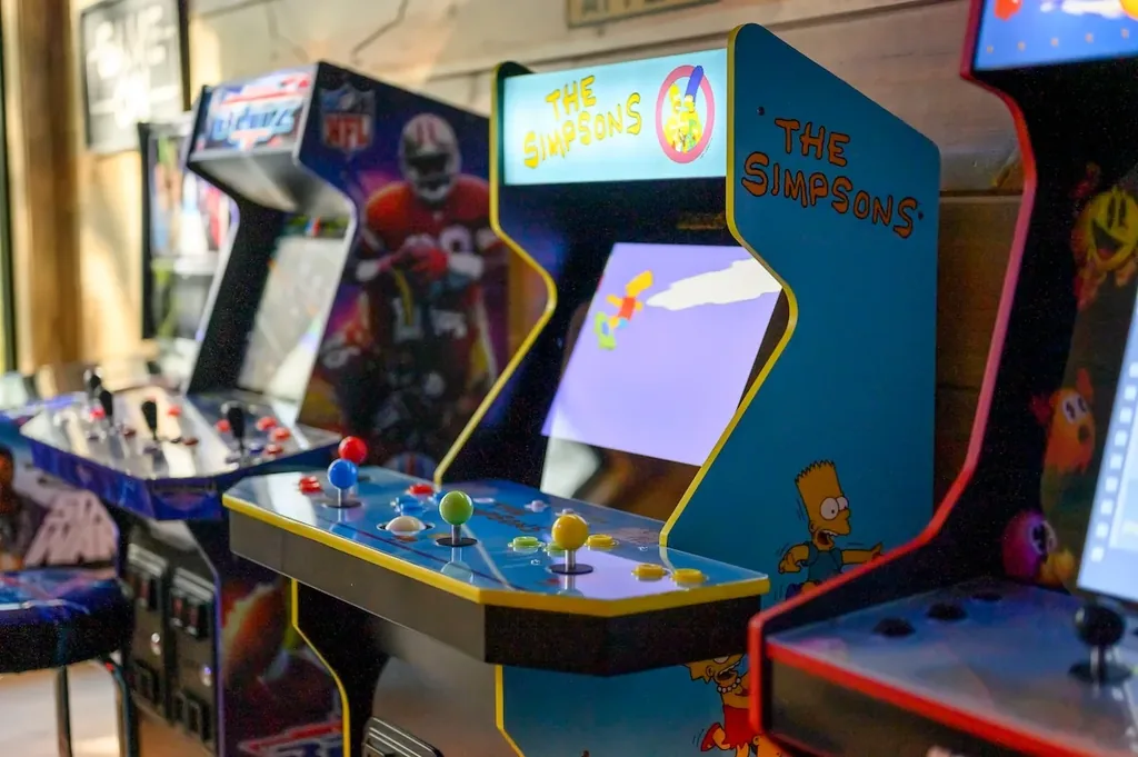 Close view of The Simpsons and Pac-Man arcade cabinets