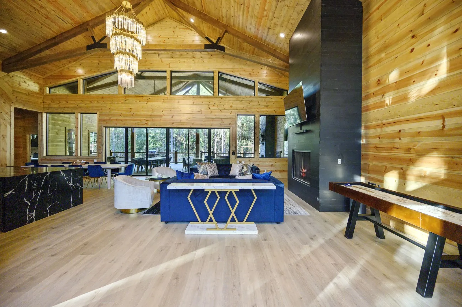 Kitchen island at The Avalon with black marble countertop, bar stools, and warm wood ceiling overhead