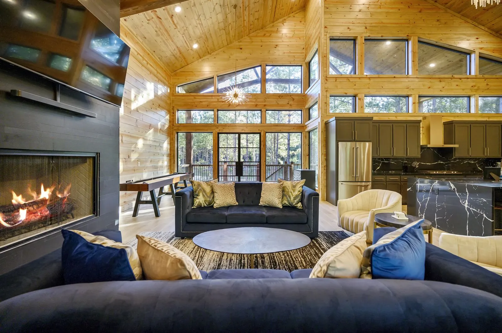 Living area at The Avalon with a lit gas fireplace and lounge seating