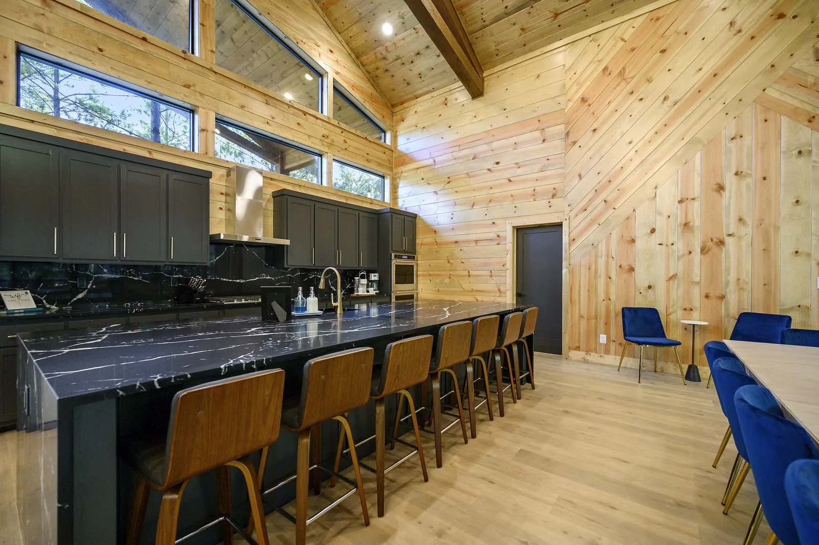 Black marble waterfall island with bar seating at The Avalon