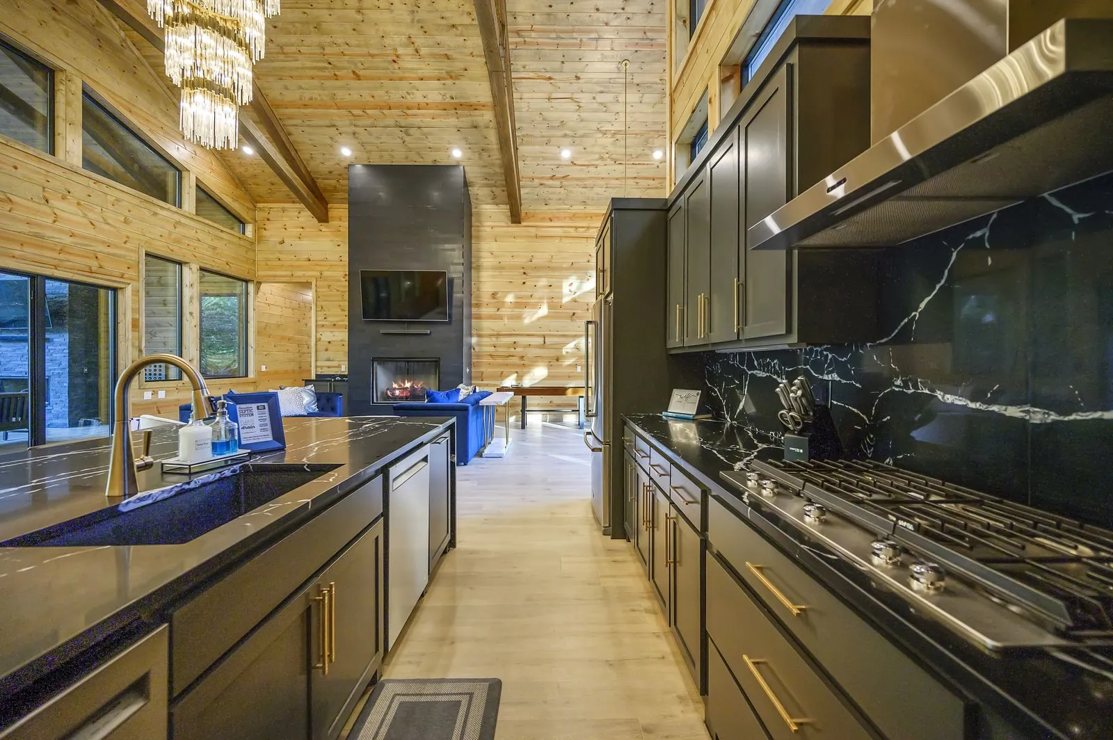 Kitchen detail at The Avalon with dark cabinetry, black marble countertops, and espresso machine