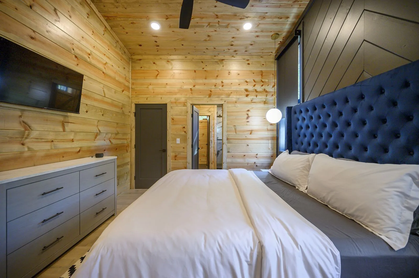 Bunk room from side angle at The Avalon with built-in bunks, storage steps, and window light