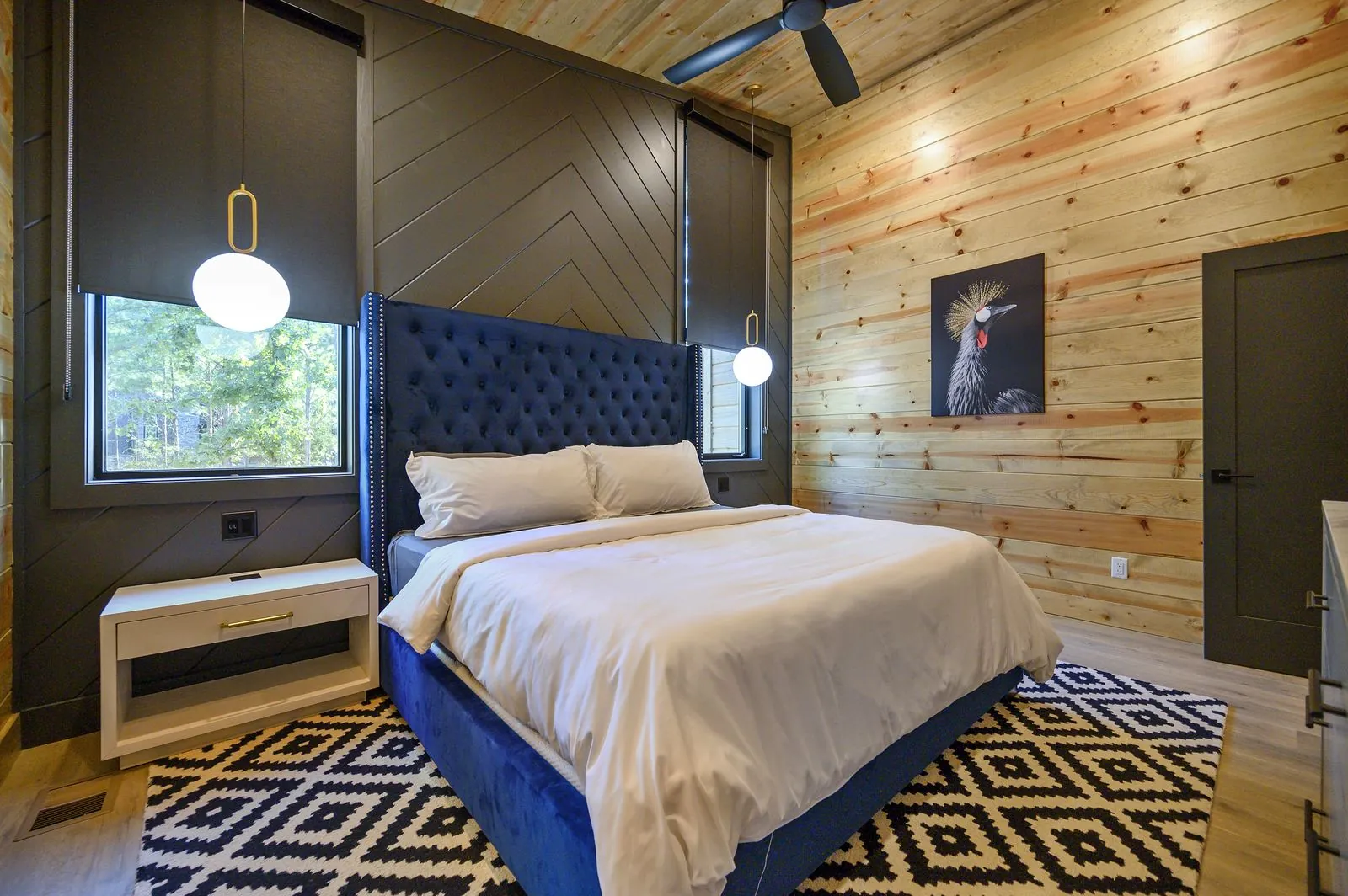 King suite 1 at The Avalon with a navy velvet headboard and black feature wall