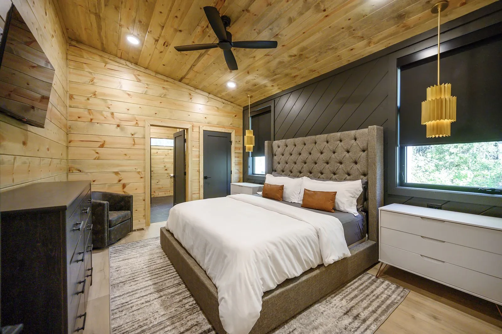 King suite 3 at The Avalon with a tufted headboard under a vaulted ceiling