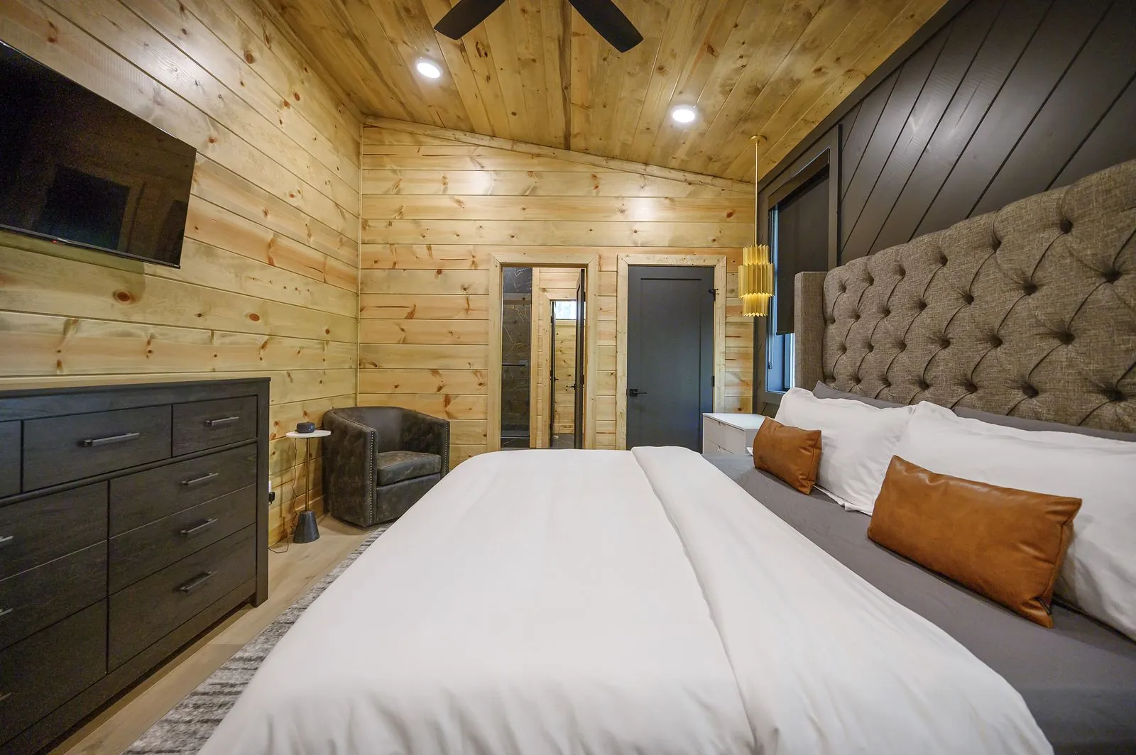 Bathroom at The Avalon showing vanity with view into king bedroom through open doorway