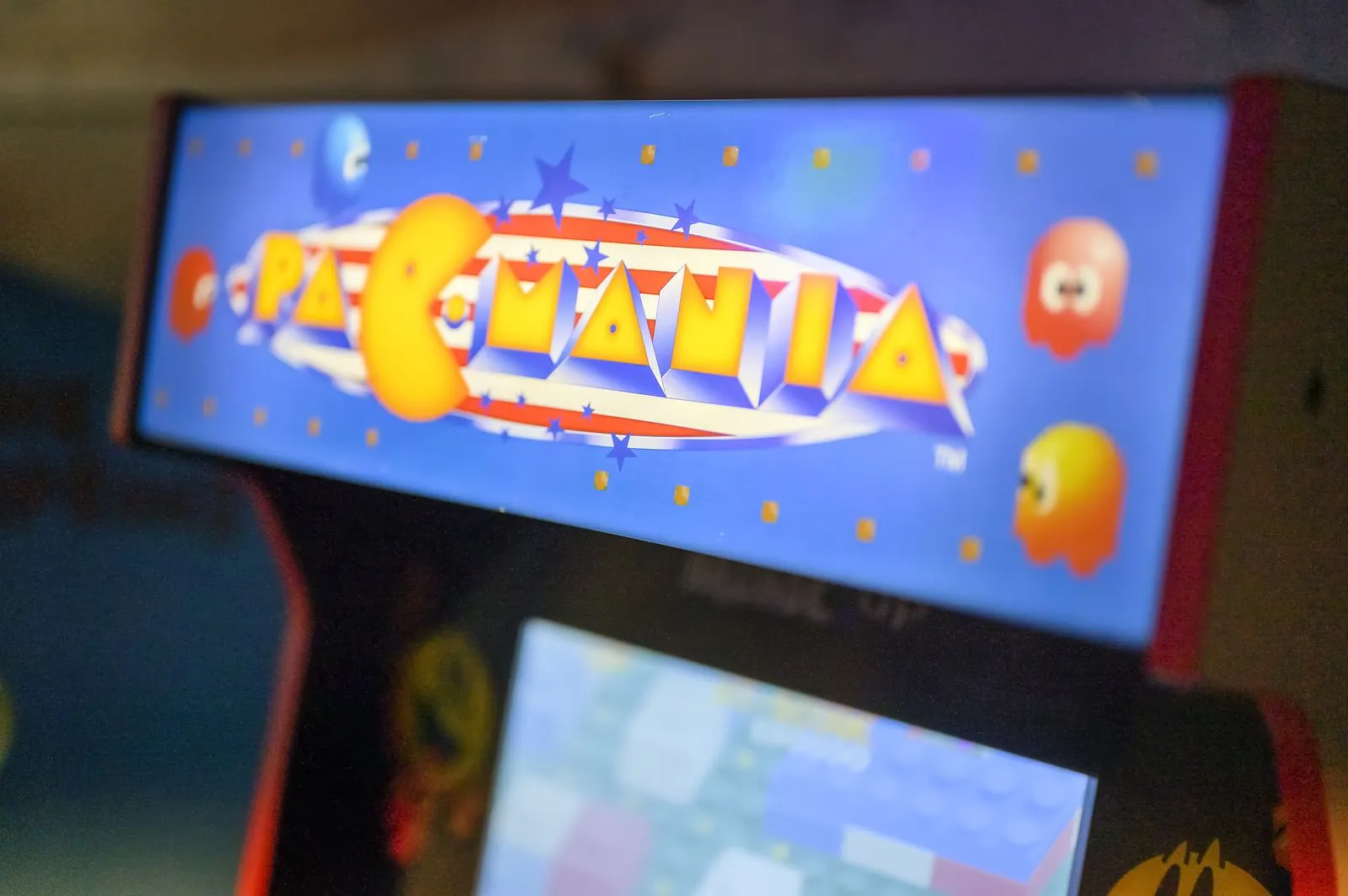 Skee-ball lane lit with blue and purple LED lights in The Avalon game room