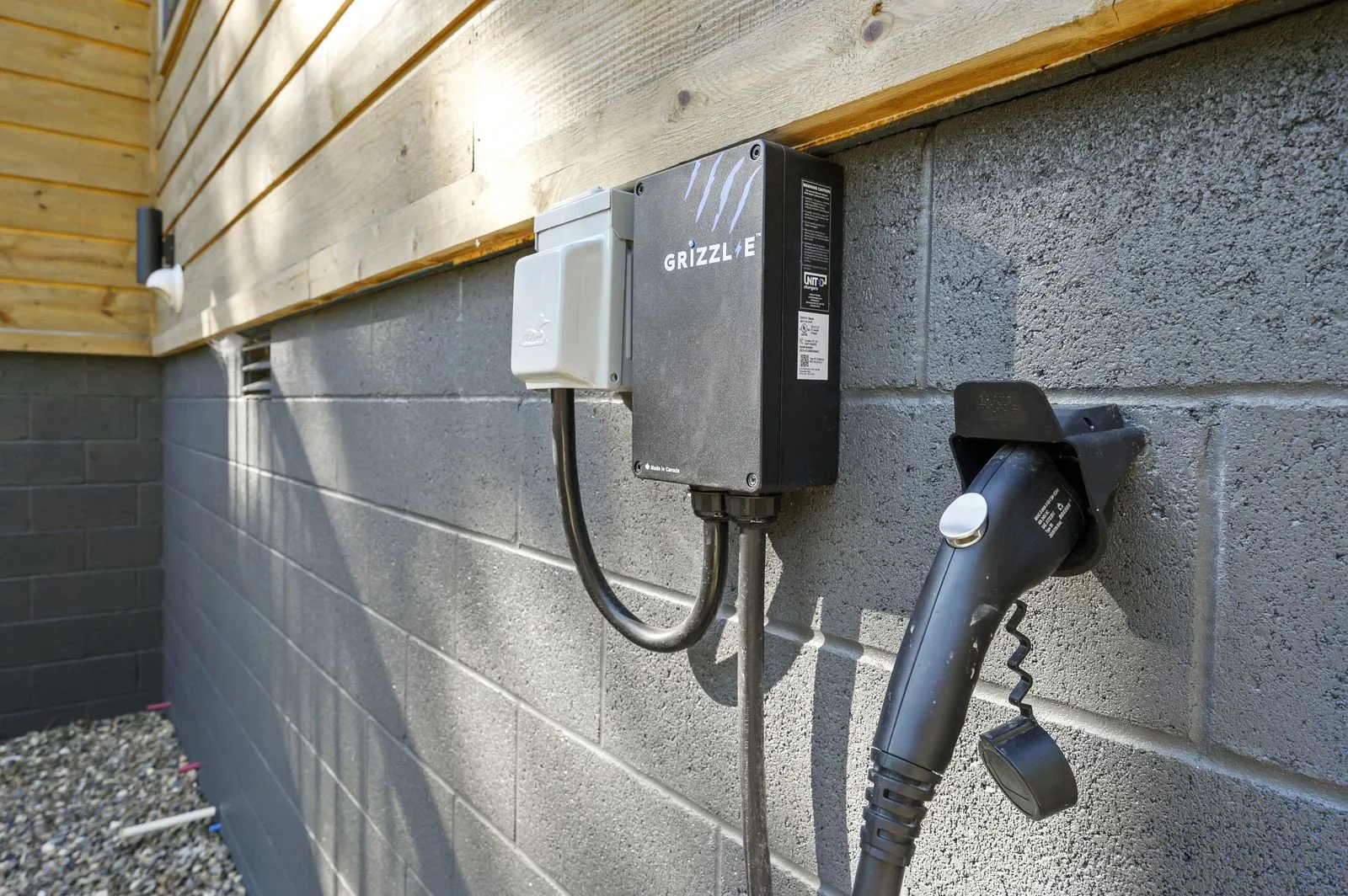 Level 2 EV charger station mounted on exterior wall at The Avalon cabin in Broken Bow