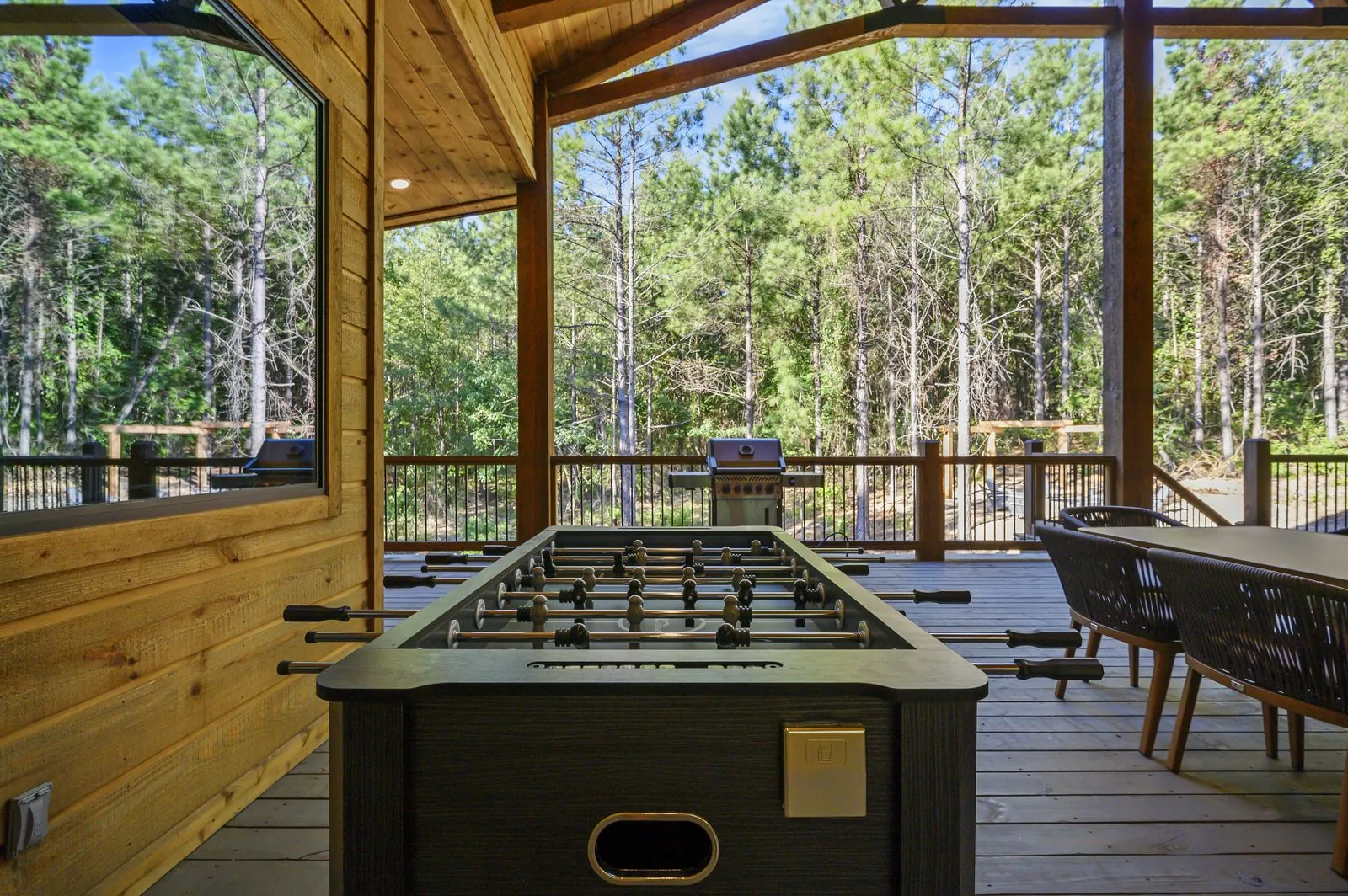 Covered pavilion at The Avalon with a foosball table overlooking the trees