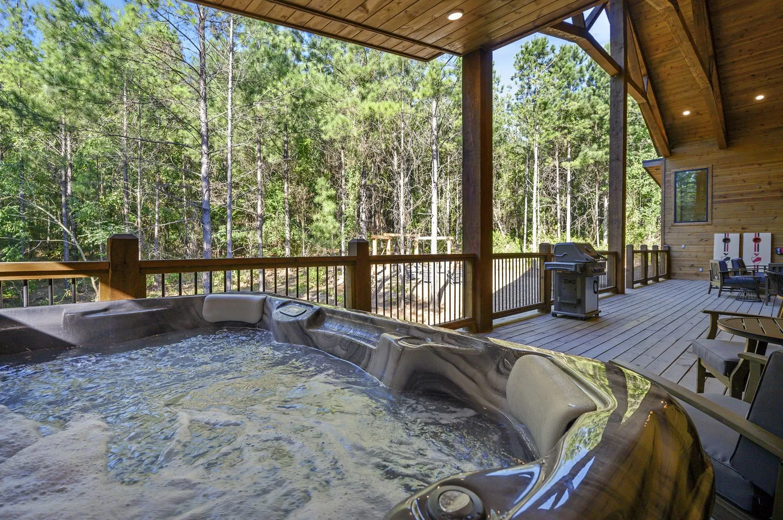 Hot tub on the deck at The Avalon surrounded by pines