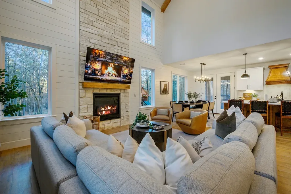 The Black-Beary — Gather around the stone fireplace in a soaring, light-filled living room that flows straight into the dining area and kitchen.