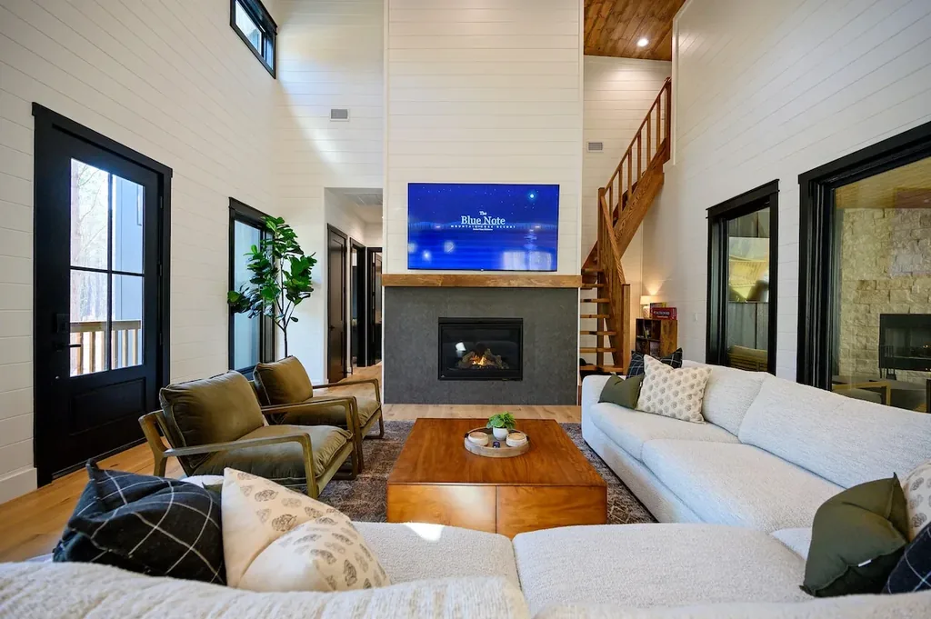 Blue Note — High ceilings and a gas fireplace anchor the living area, with plenty of seating for the whole group.