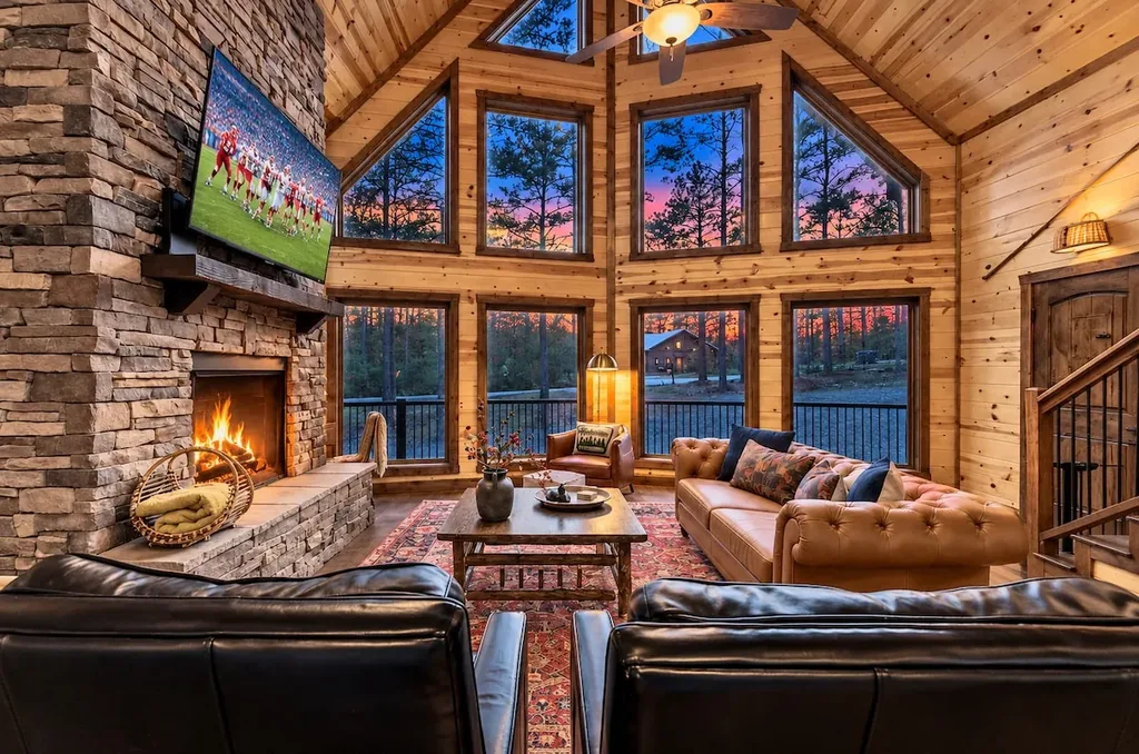 Vaulted great room at Cami's Campout with stone fireplace and forest views