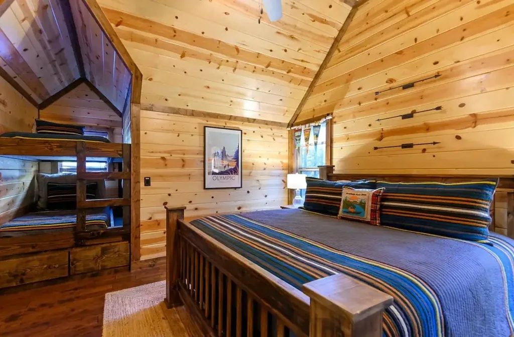 King bed and twin bunk in the upstairs bedroom at Cami's Campout