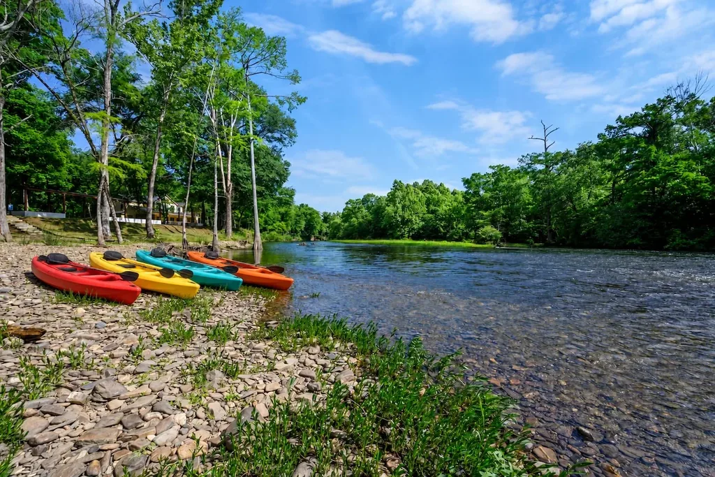 Community river beach and kayaks on the Mountain Fork River