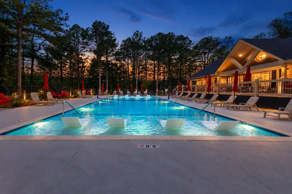 Dolce Far Nient — This shared resort pool has in-water lounge seating, a volleyball net, and deck chairs, with a lit clubhouse behind it. It is available to guests at no extra cost.