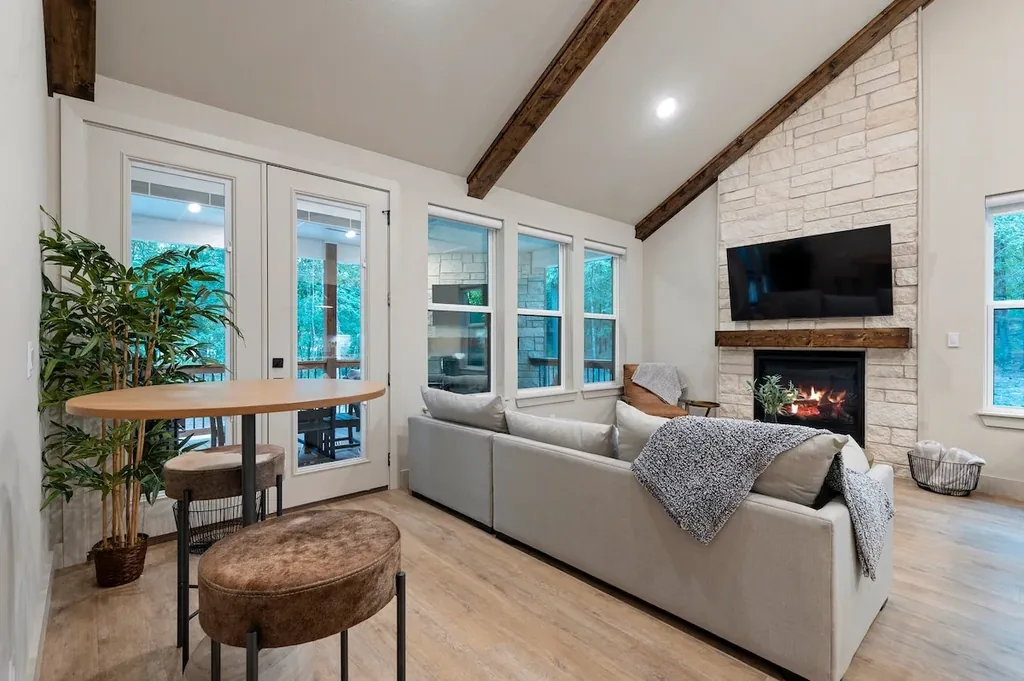Dolce Far Nient — Gather around the stone fireplace beneath vaulted beamed ceilings in a living room that opens straight onto the private balcony.