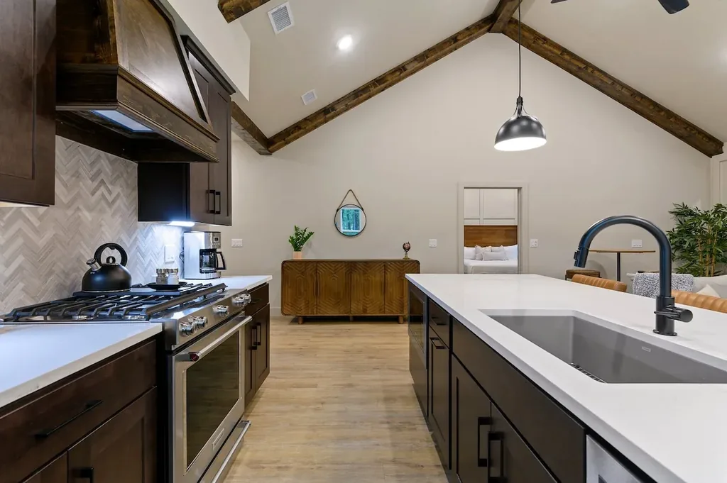 Dolce Far Nient — Cook a full meal in a well-equipped kitchen with a gas range, oversized island, and views into the open living space.