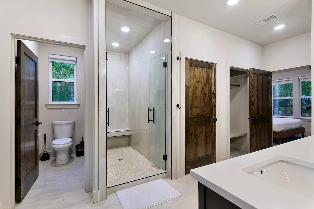 Dolce Far Nient — A spacious glass-enclosed shower and separate toilet room give this private bathroom a spa-like feel.