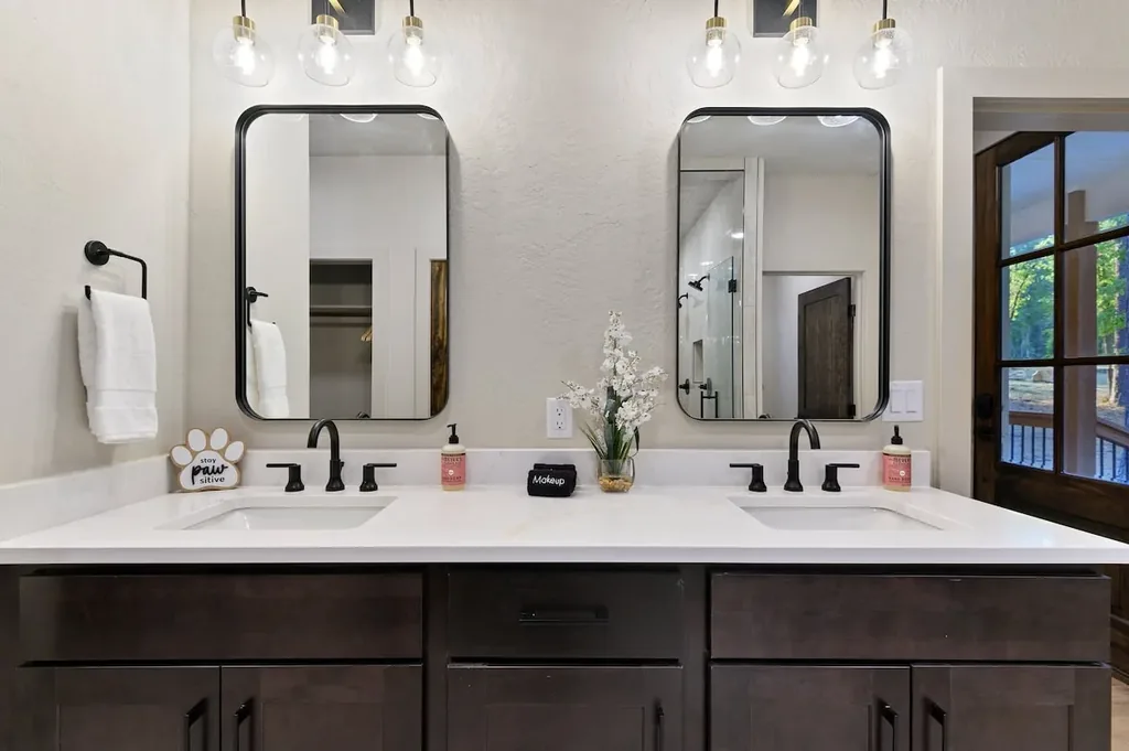 Dolce Far Nient — Get ready side by side at a spacious double vanity with plenty of counter space and a private walk-in shower just steps away.
