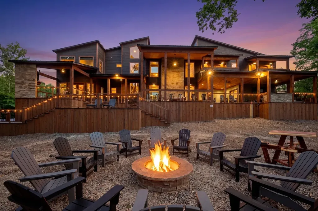 Rear creekside exterior and fire pit at Dreams & Streams at twilight