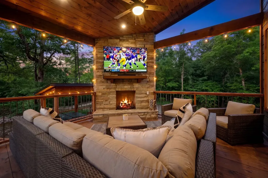 Covered outdoor lounge with fireplace and television at Dreams & Streams
