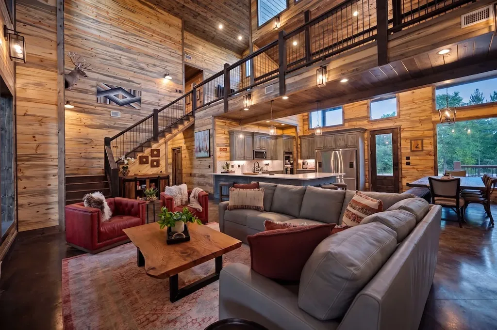 Great room with vaulted ceiling, kitchen, and dining area at Dreams & Streams