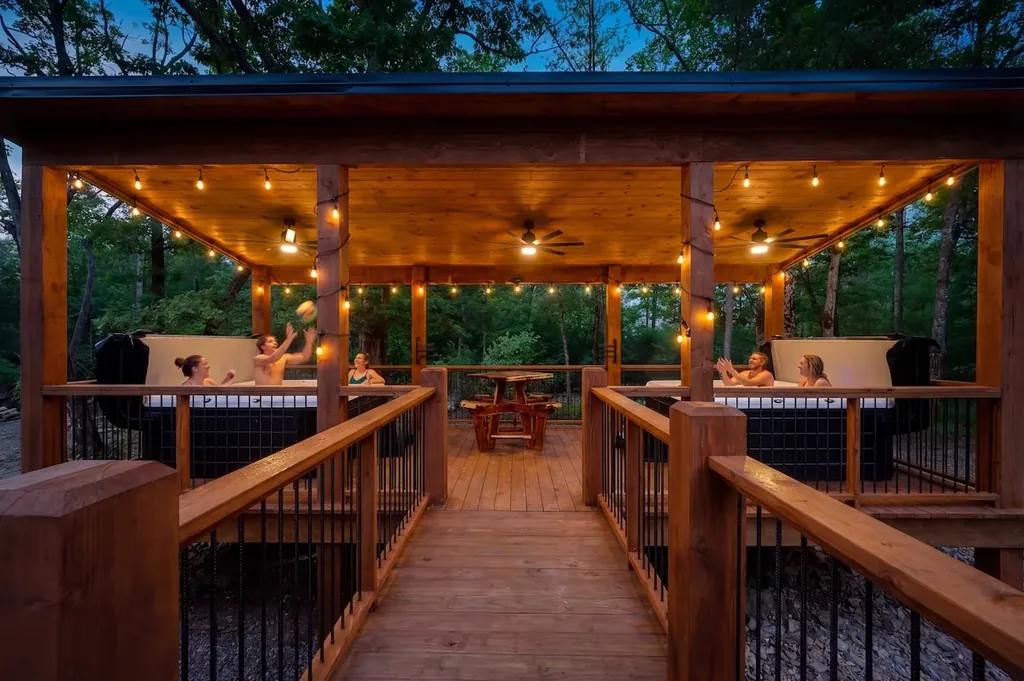 Guests enjoying the covered hot tub area at Dreams & Streams