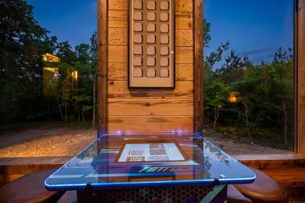 Tabletop arcade game beside the forest-view windows