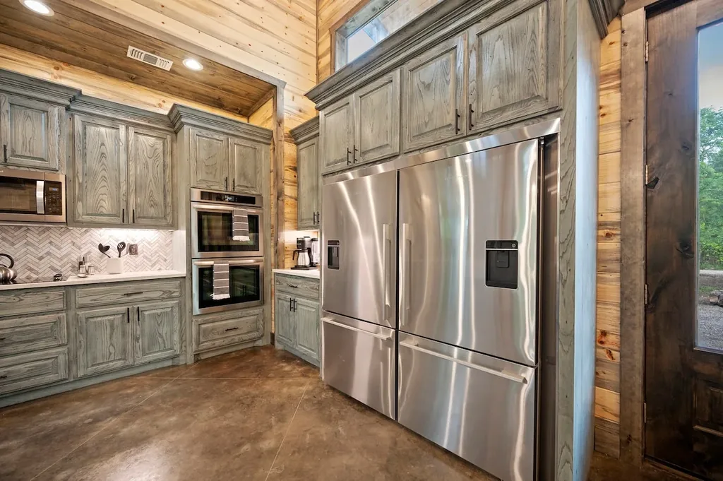 Double ovens and two refrigerators in the full kitchen