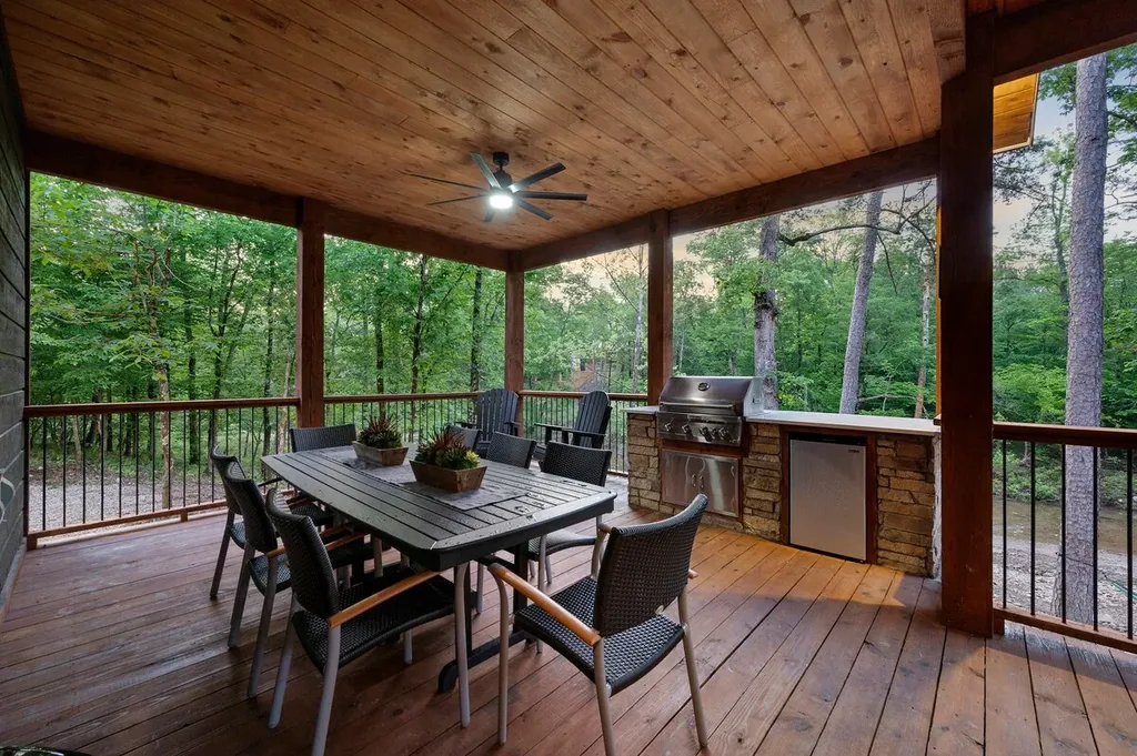 Covered outdoor kitchen and dining area beside the creek
