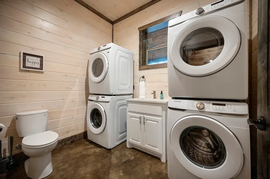Laundry room with two stacked washer and dryer sets