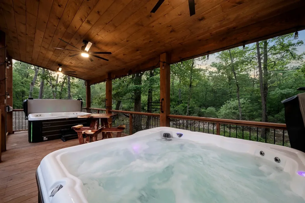 Covered hot tub overlooking the forest and creek