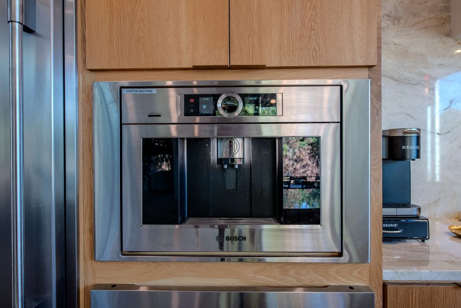 Close-up of built-in wall oven and integrated coffee station in The Jade gourmet kitchen