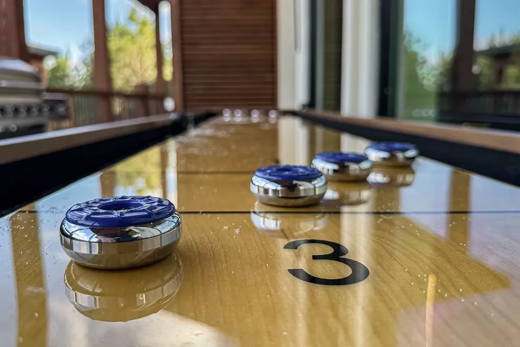 Close-up of shuffleboard pucks on the numbered table