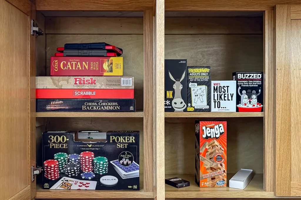 Cabinet stocked with board games, poker, Jenga, and playing cards