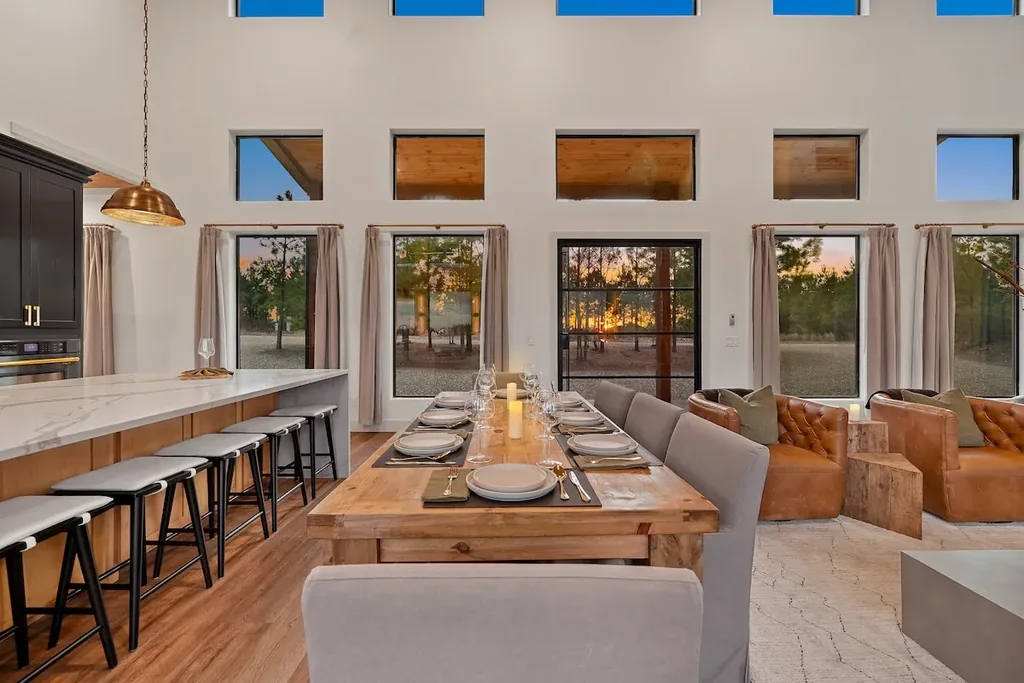 Set dining table between the kitchen island and living room
