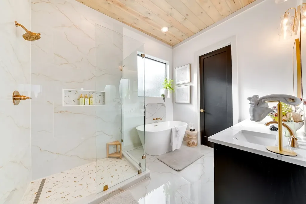 Full Bathroom 1 with marble walk-in shower and gold fixtures