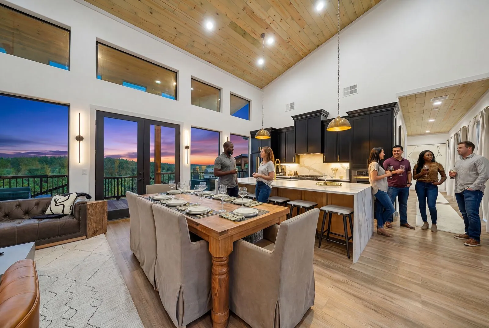 Open kitchen and dining great room at The Malibu with vaulted ceiling and forest views