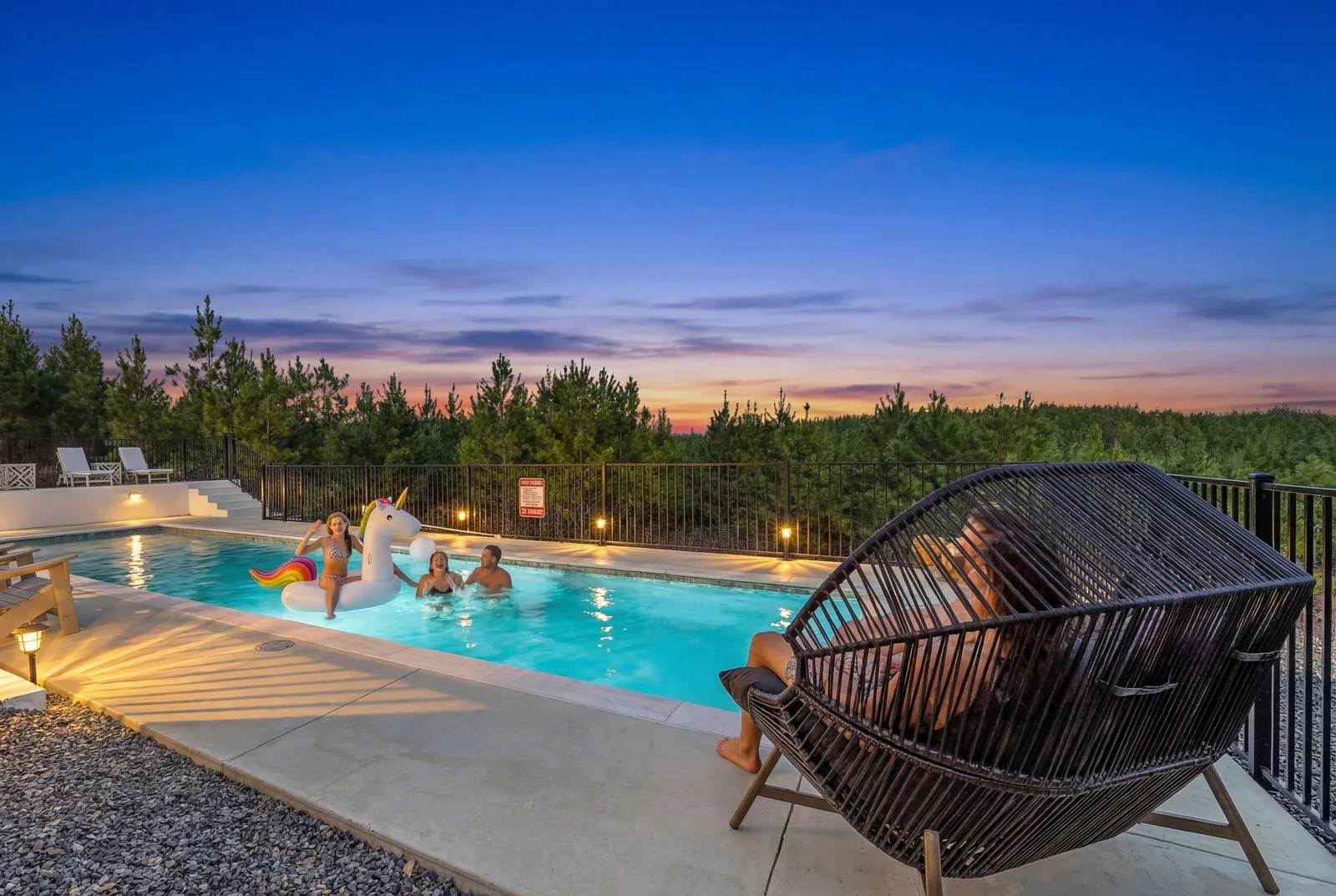 Guests enjoying the heated pool at The Malibu in the evening